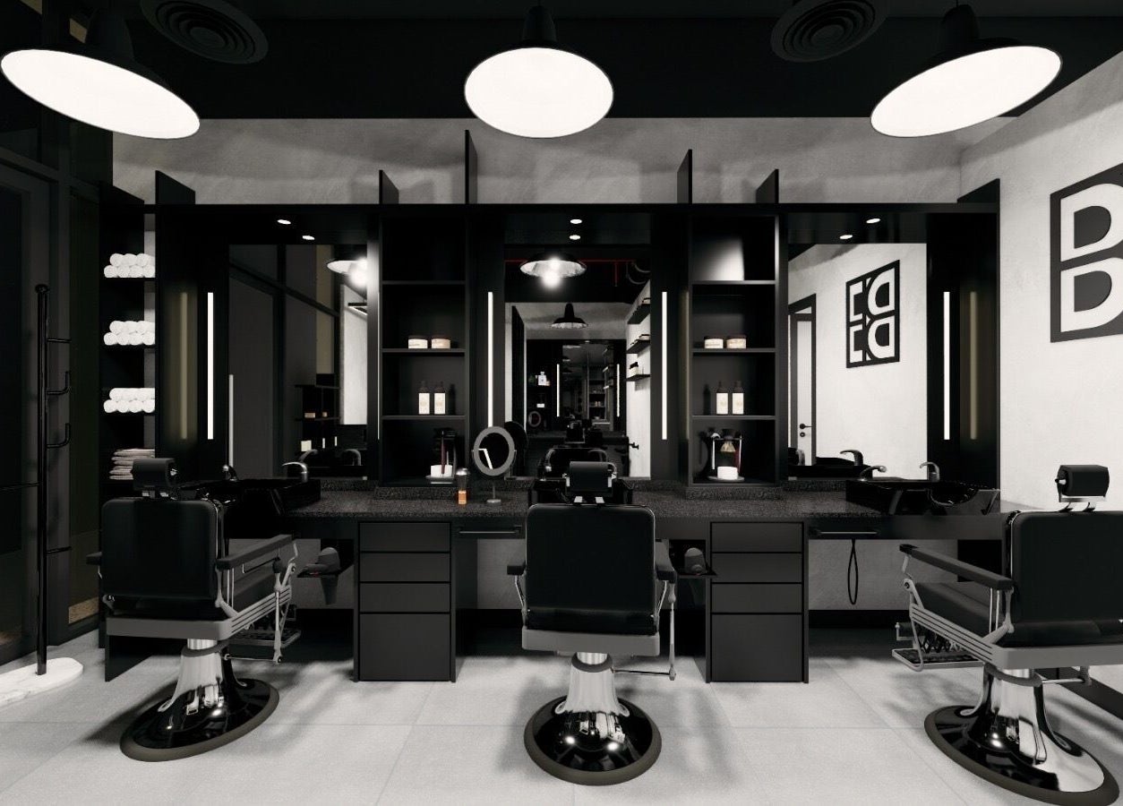 Modern interior of Budz and Broz Barbershop in Dubai, Dubai, AE with sleek black chairs and lit mirrors.