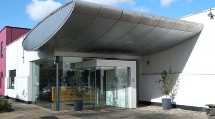 Entrance to Holistic Calibration, London, England, GB with sleek design and large glass doors.
