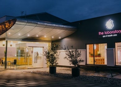 Holistic Calibration venue entrance at night in London, England, GB, warmly lit and inviting.
