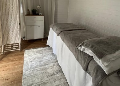 Peaceful massage room at BelleVie Wellness in Liverpool, England, GB, with cozy linens on a treatment table.
