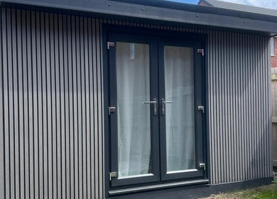Elegant outdoor cabin at BelleVie Wellness, Liverpool, England, GB, showcasing sleek design and privacy.