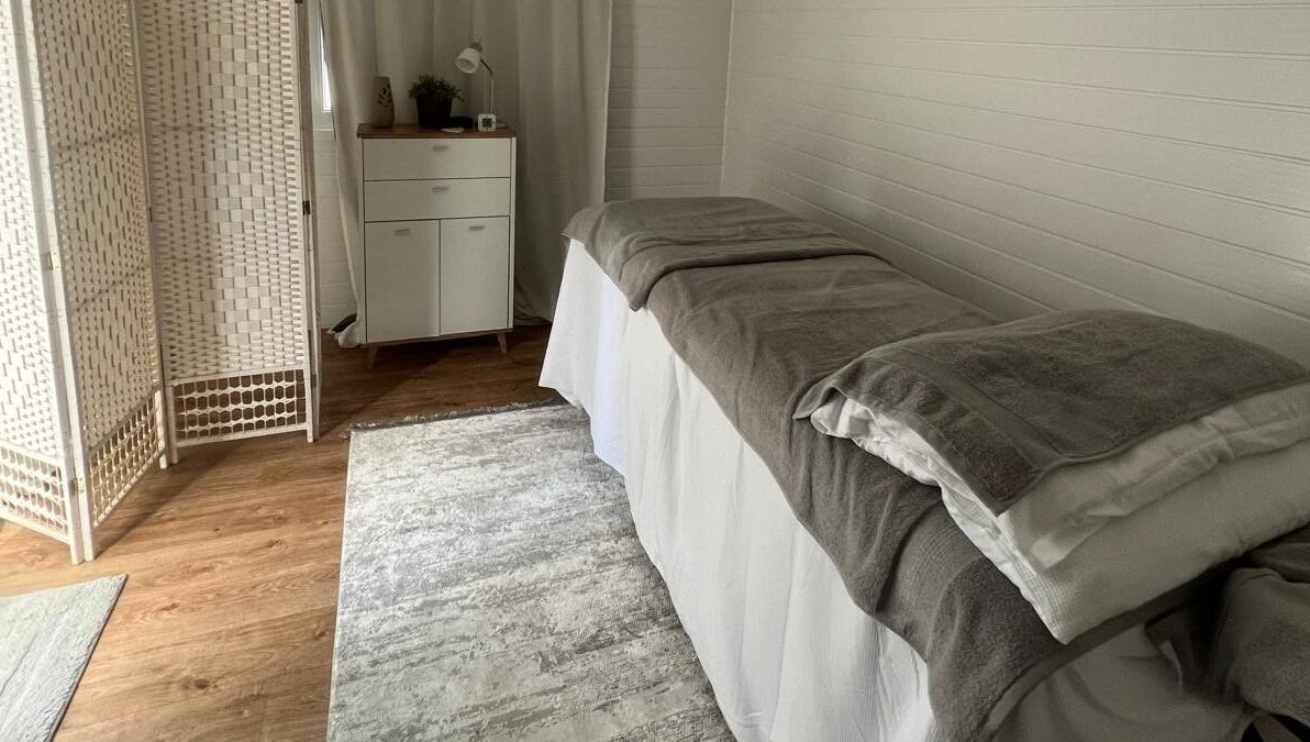 Relaxing massage room at BelleVie Wellness, Liverpool, England, GB, featuring soft lighting and cozy decor.