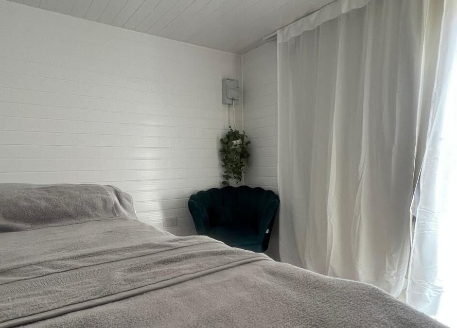 Cozy relaxation room at BelleVie Wellness, Liverpool, England, GB with bed and chair.