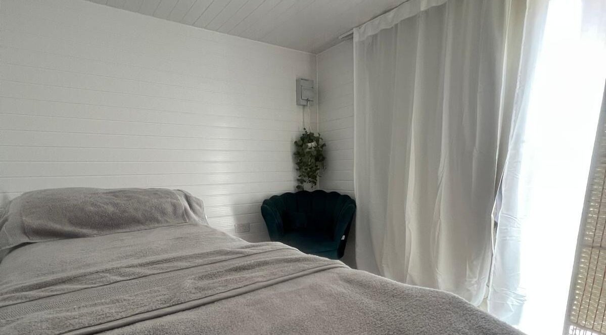 Cozy relaxation room at BelleVie Wellness, Liverpool, England, GB with bed and chair.