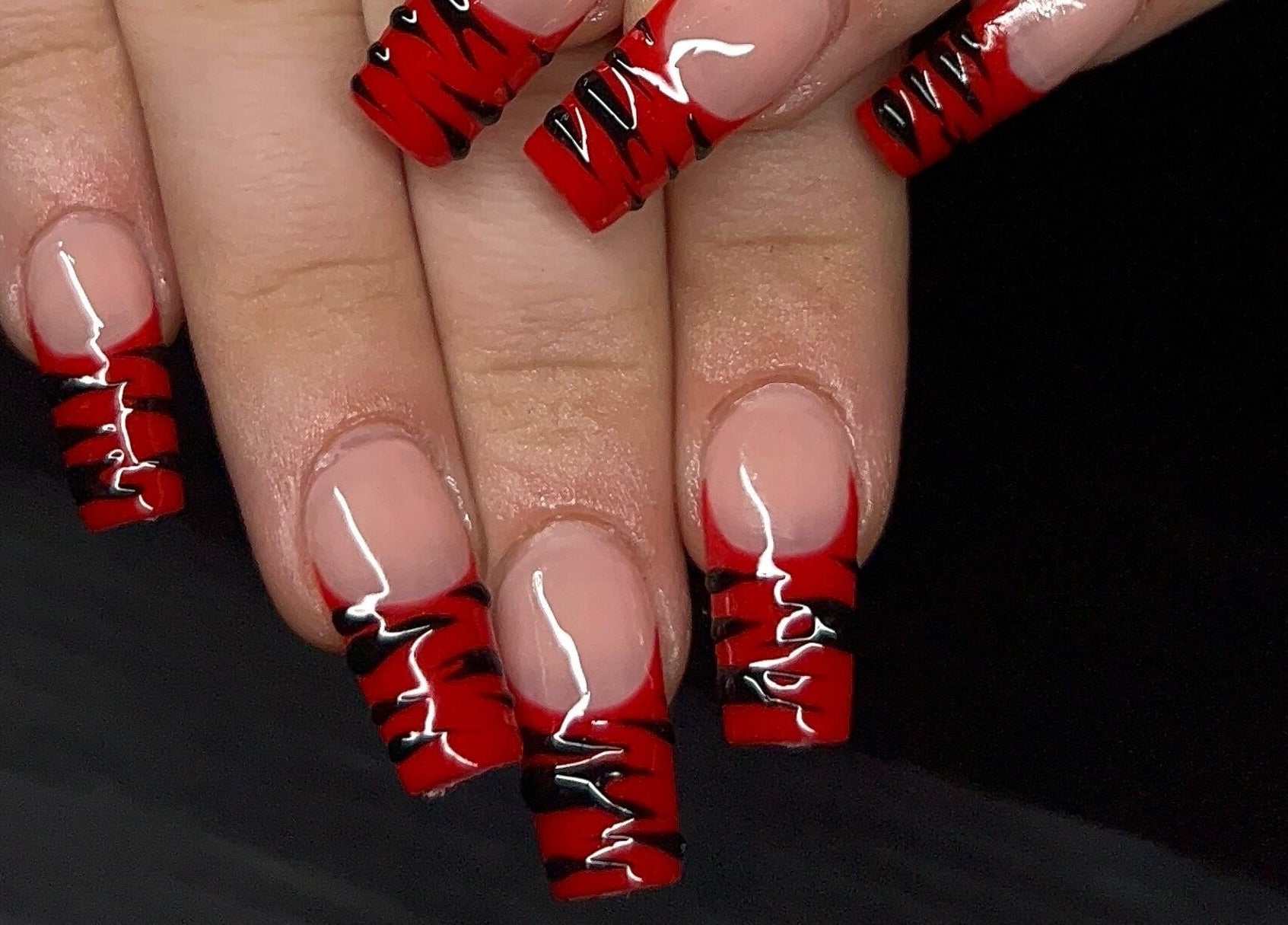 Stylish red and black nail art at Nevar Beauty, Richlands, Queensland, AU.