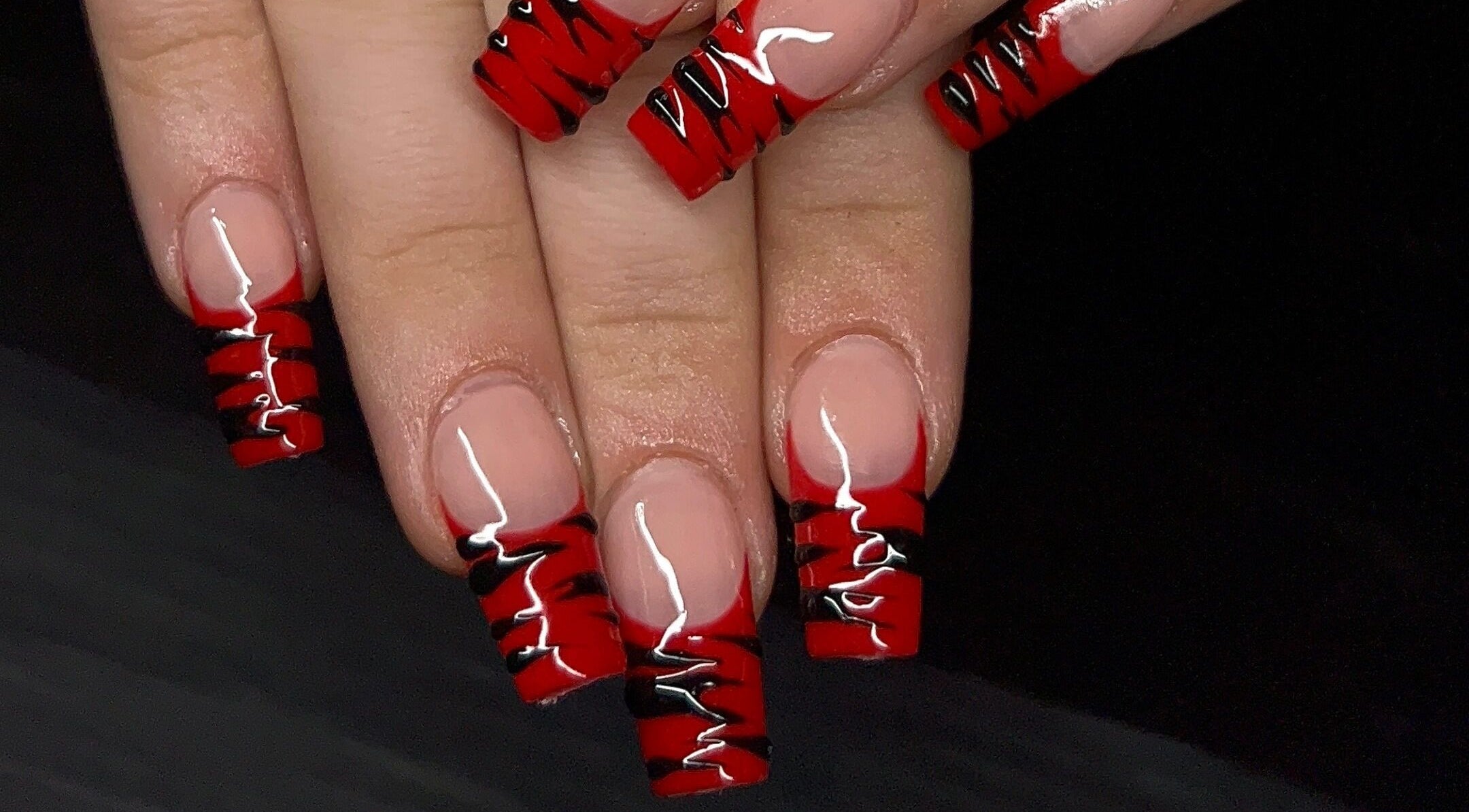 Stylish red and black nail art at Nevar Beauty, Richlands, Queensland, AU.