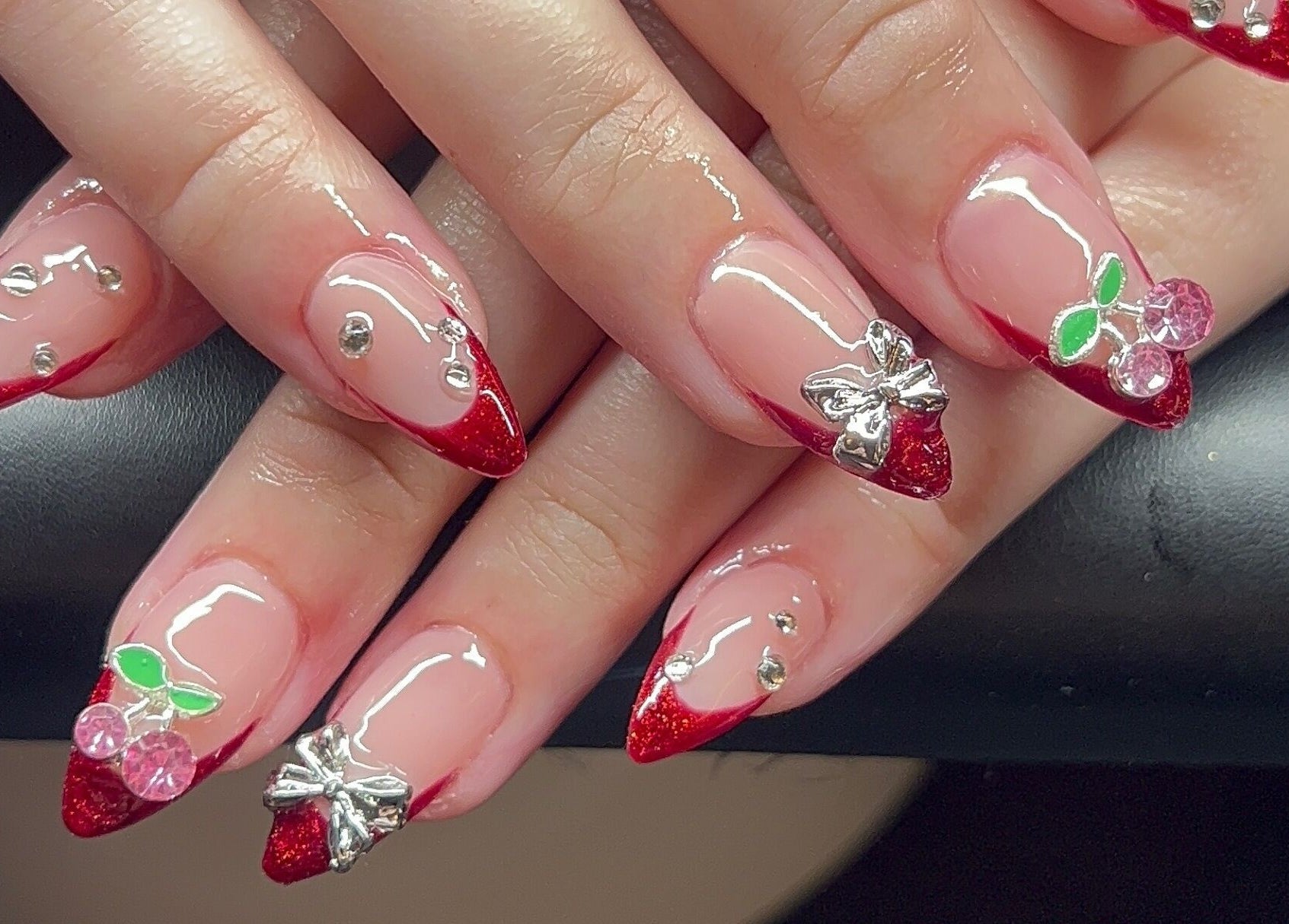 Red glitter stiletto nails with gems at Nevar Beauty, Richlands, Queensland, AU.