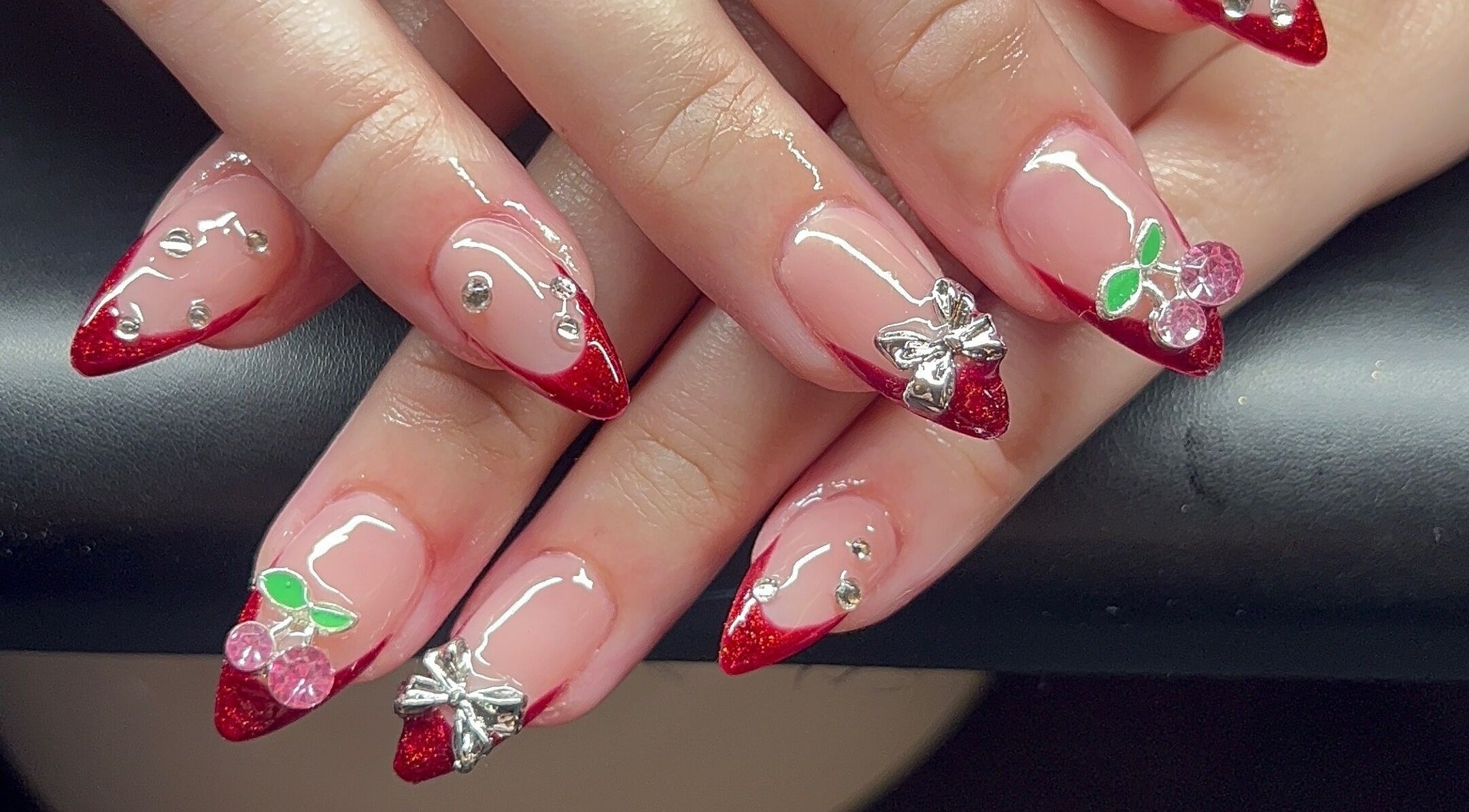 Red glitter stiletto nails with gems at Nevar Beauty, Richlands, Queensland, AU.