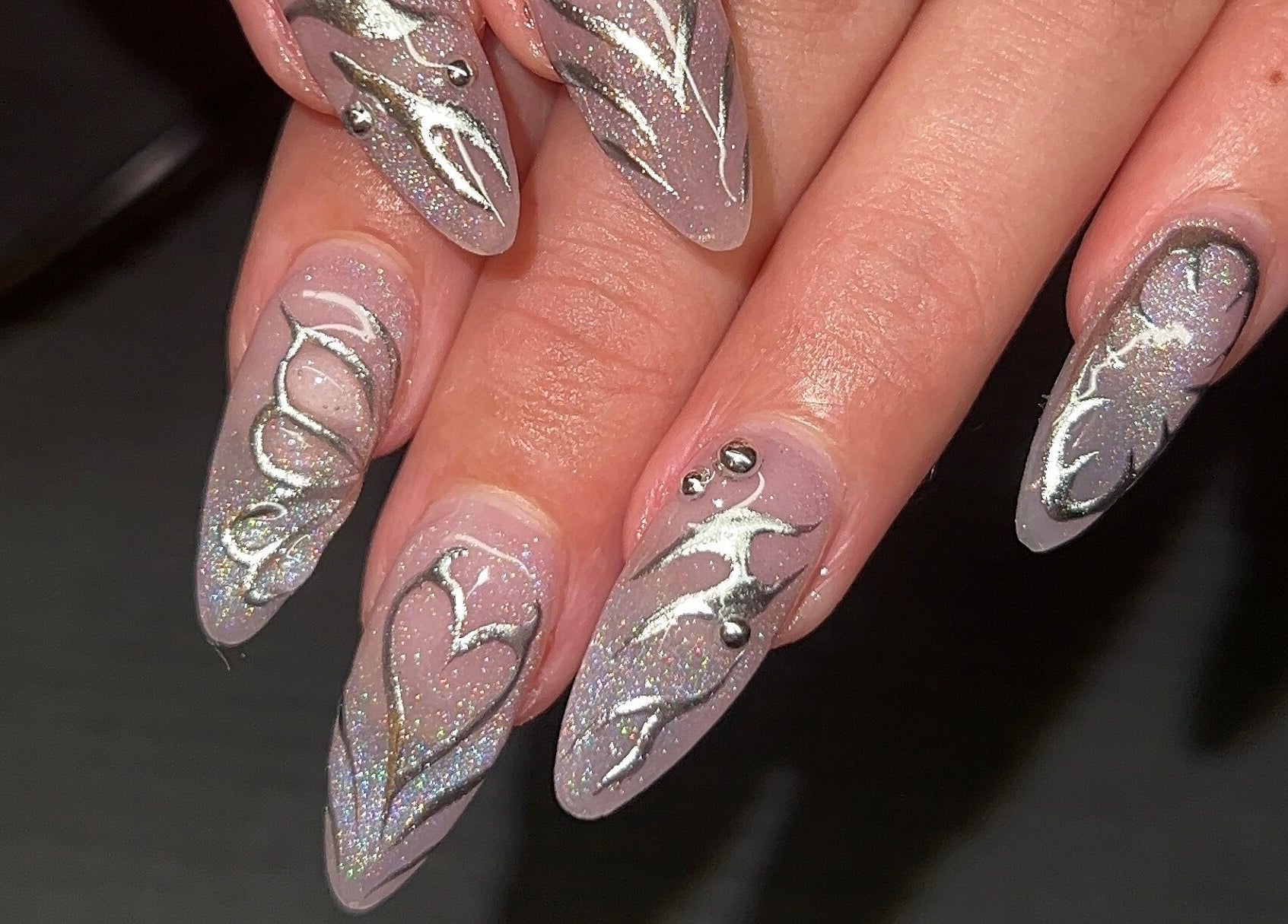 Elegant nail art with silver accents at Nevar Beauty, Richlands, Queensland, AU.