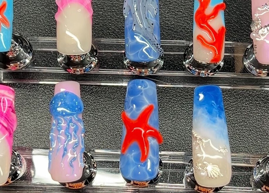 Artistic nail designs at Nevar Beauty in Richlands, Queensland, AU. Vibrant colors and 3D accents showcased.
