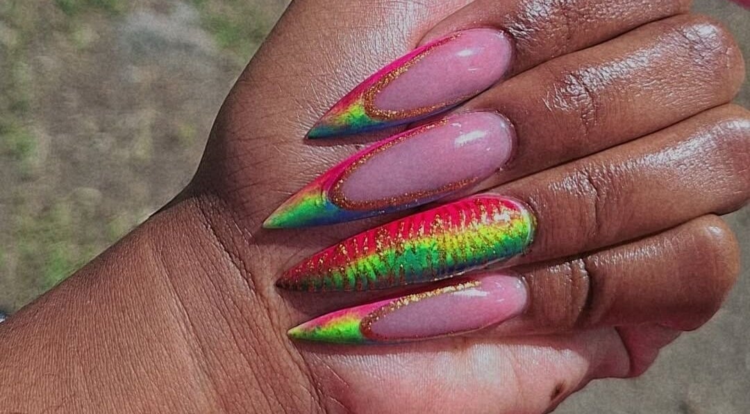 Vibrant rainbow stiletto nails at J's fullhousebeauty, Saint Philip, Bridgetown, BB. Perfect for a bold style.