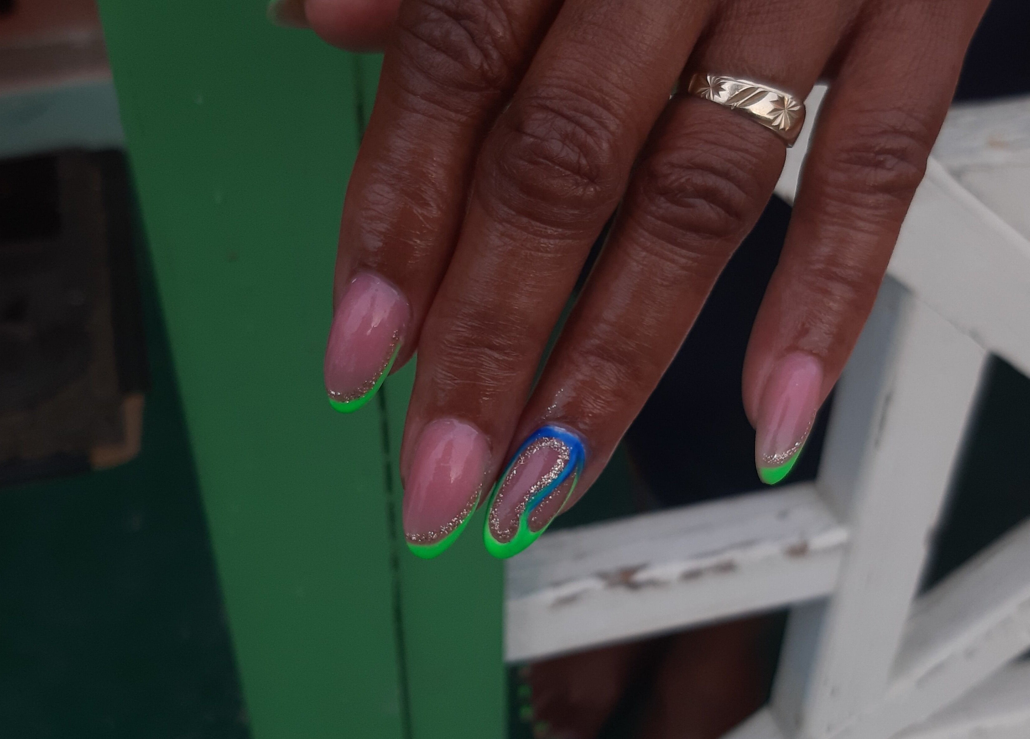 Stylish nail art featuring green tips and a blue accent at J's fullhousebeauty, Saint Philip, Bridgetown, BB.