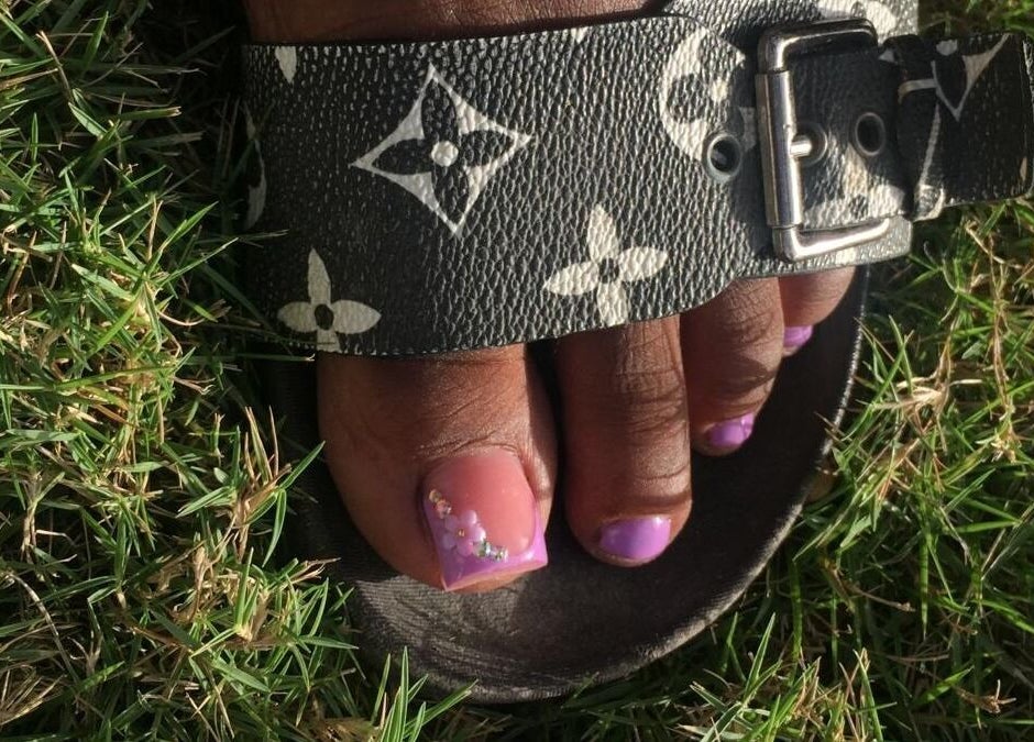 Chic pedicure with purple polish at J's fullhousebeauty, Saint Philip, Bridgetown, BB, showcasing stylish sandal.