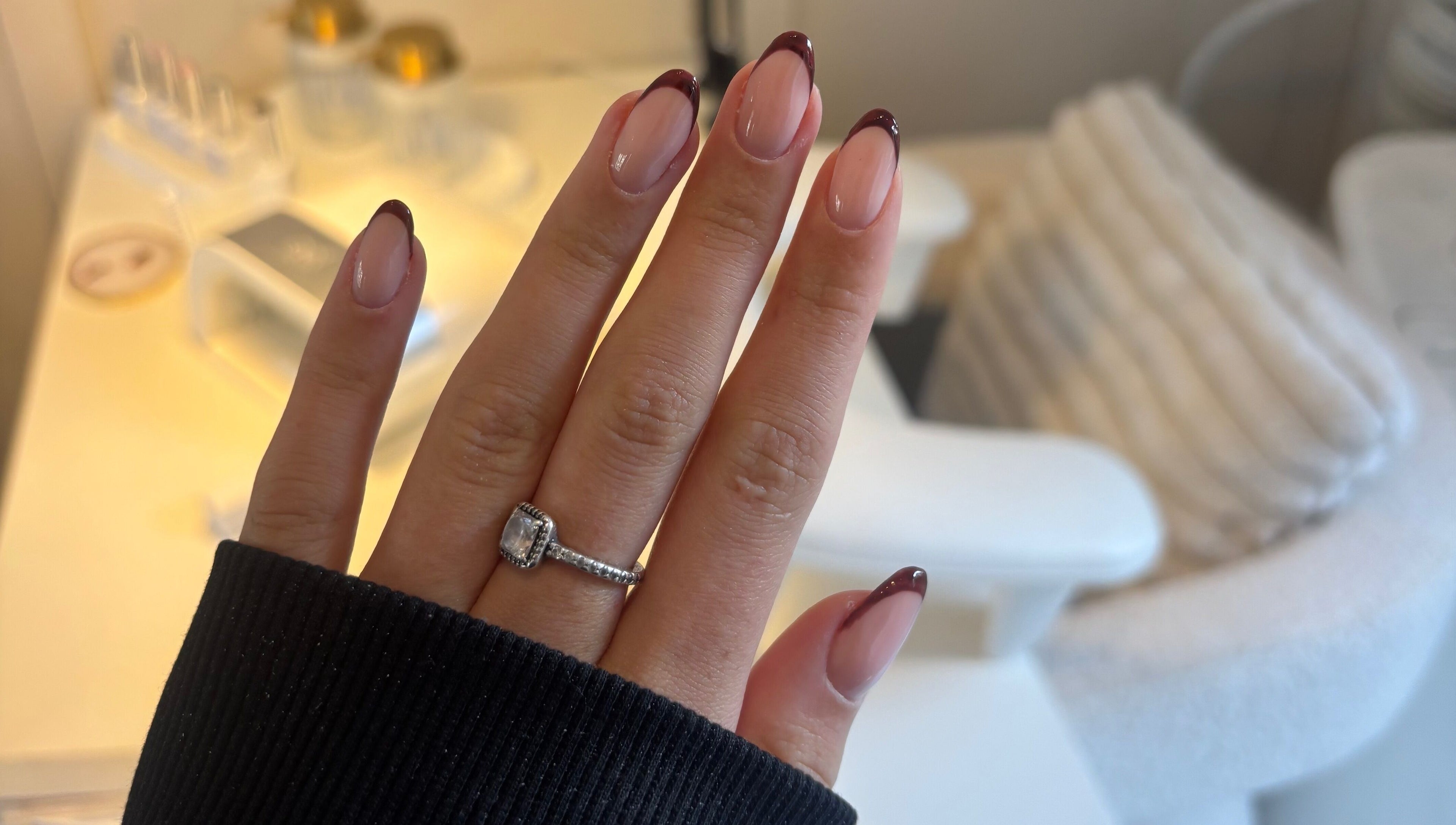 Stylish manicure with dark red tips at TheAngelSalon, Tonbridge, England, GB, showcasing elegant nail art.