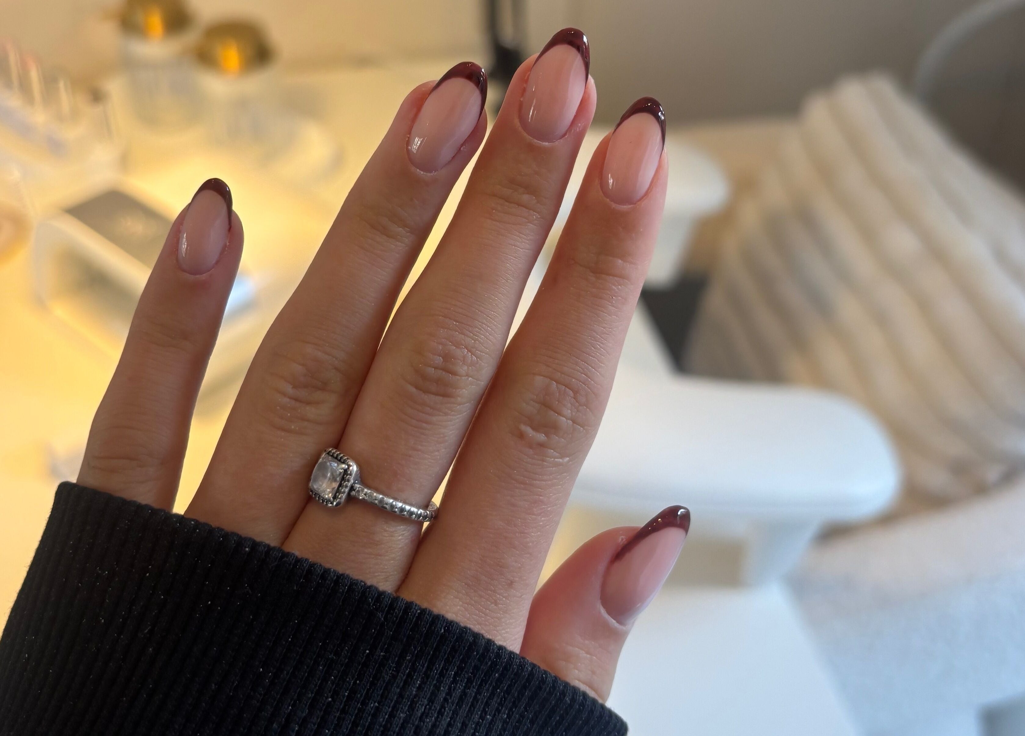 Stylish manicure with dark red tips at TheAngelSalon, Tonbridge, England, GB, showcasing elegant nail art.