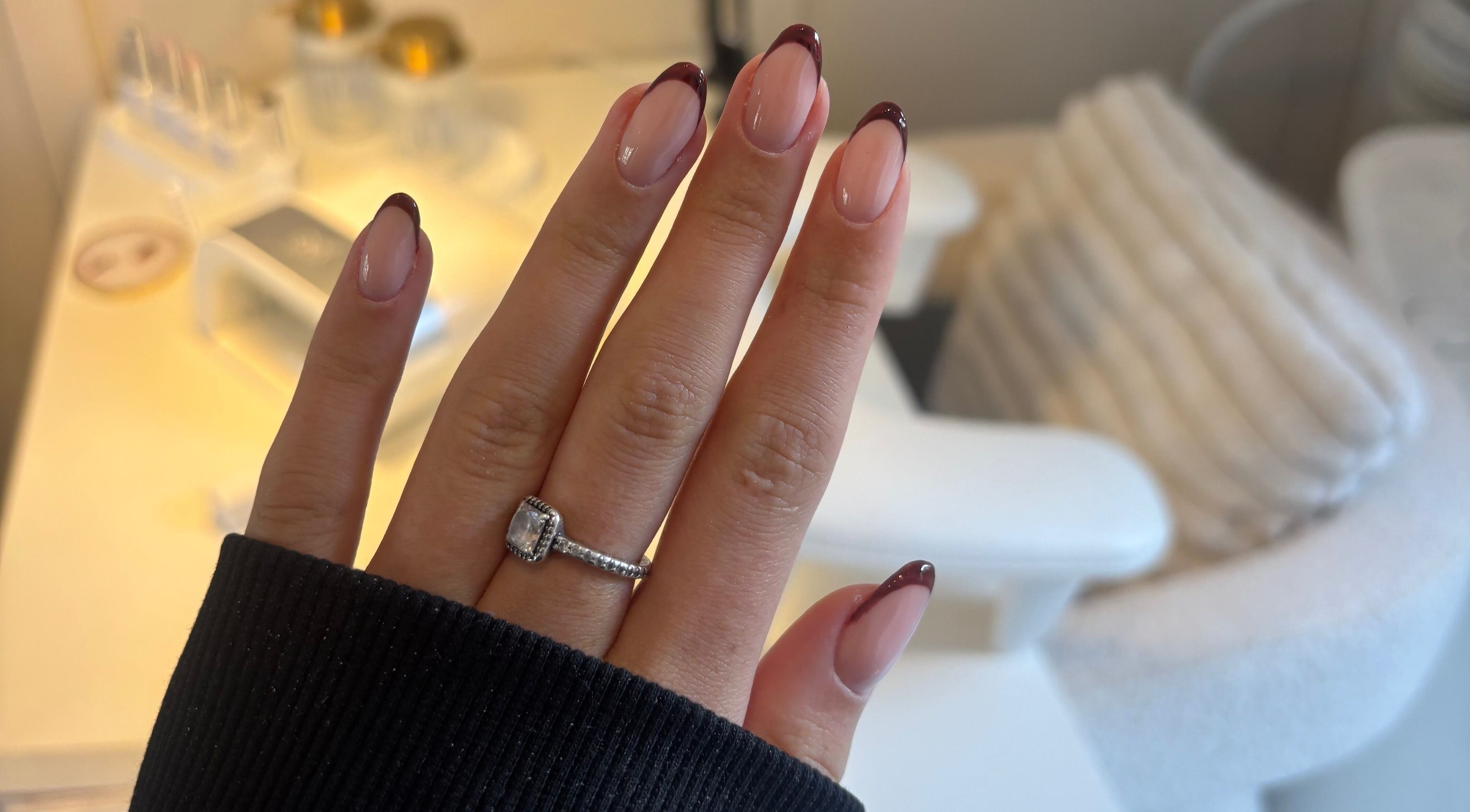 Stylish manicure with dark red tips at TheAngelSalon, Tonbridge, England, GB, showcasing elegant nail art.