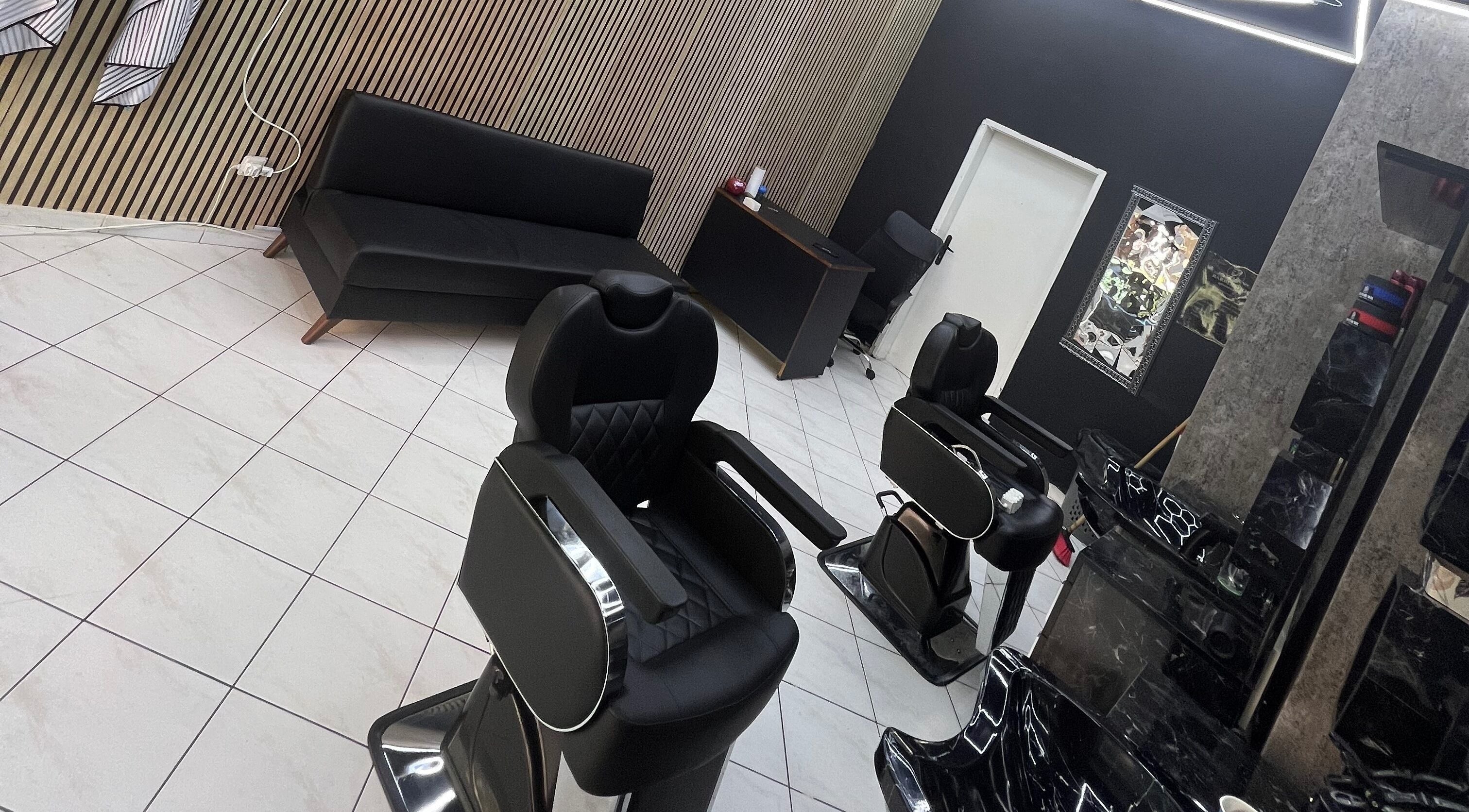 Modern black barber chairs at Meshari Barbers, Plovdiv, Plovdiv, BG, showcasing elegant salon interior.