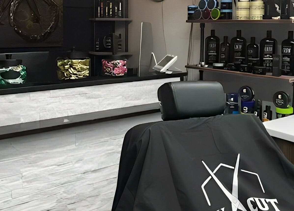 Ev Cut Barbershop's sleek interior in Calgary, Alberta, CA with a barbershop chair and stylish products.