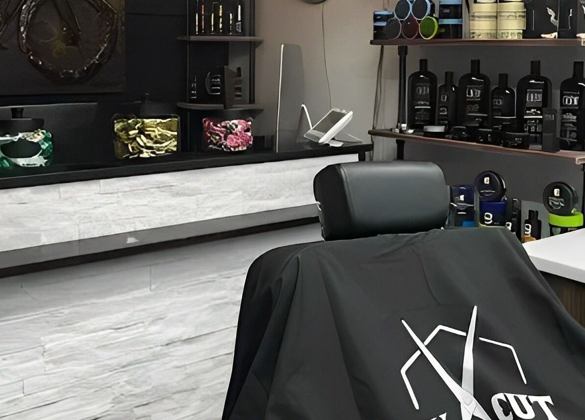 Ev Cut Barbershop's sleek interior in Calgary, Alberta, CA with a barbershop chair and stylish products.