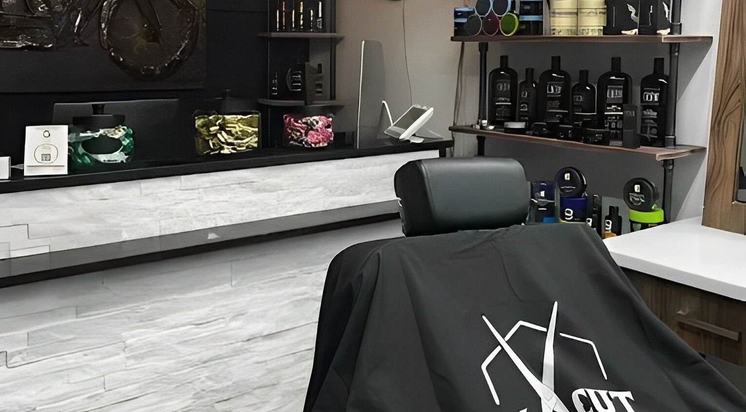 Ev Cut Barbershop's sleek interior in Calgary, Alberta, CA with a barbershop chair and stylish products.
