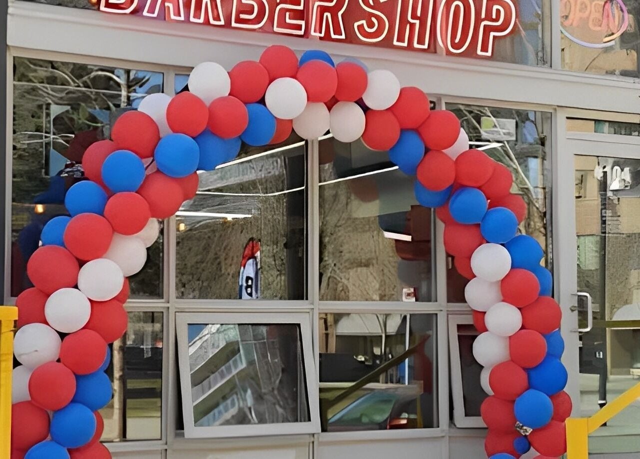 Colorful balloon arch outside Ev Cut Barbershop in Calgary, Alberta, CA welcoming visitors.