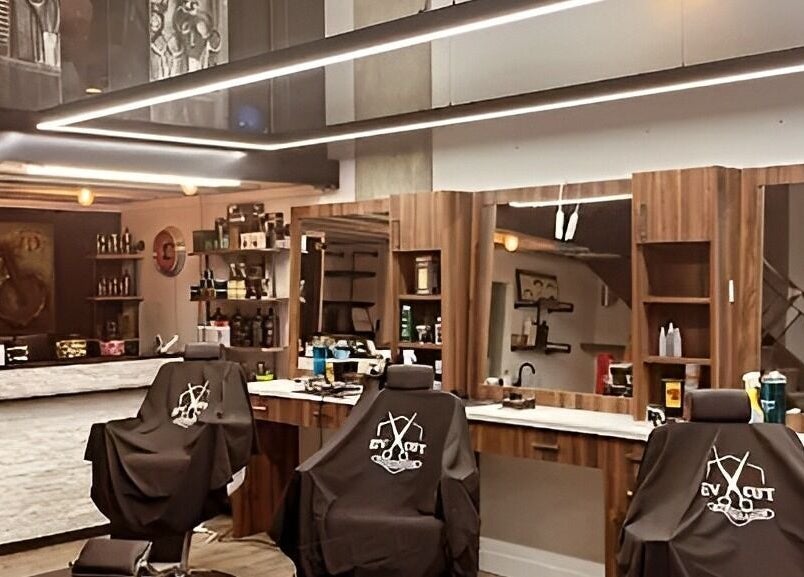Interior of Ev Cut Barbershop in Calgary, Alberta, CA showcasing sleek chairs and stylish decor.