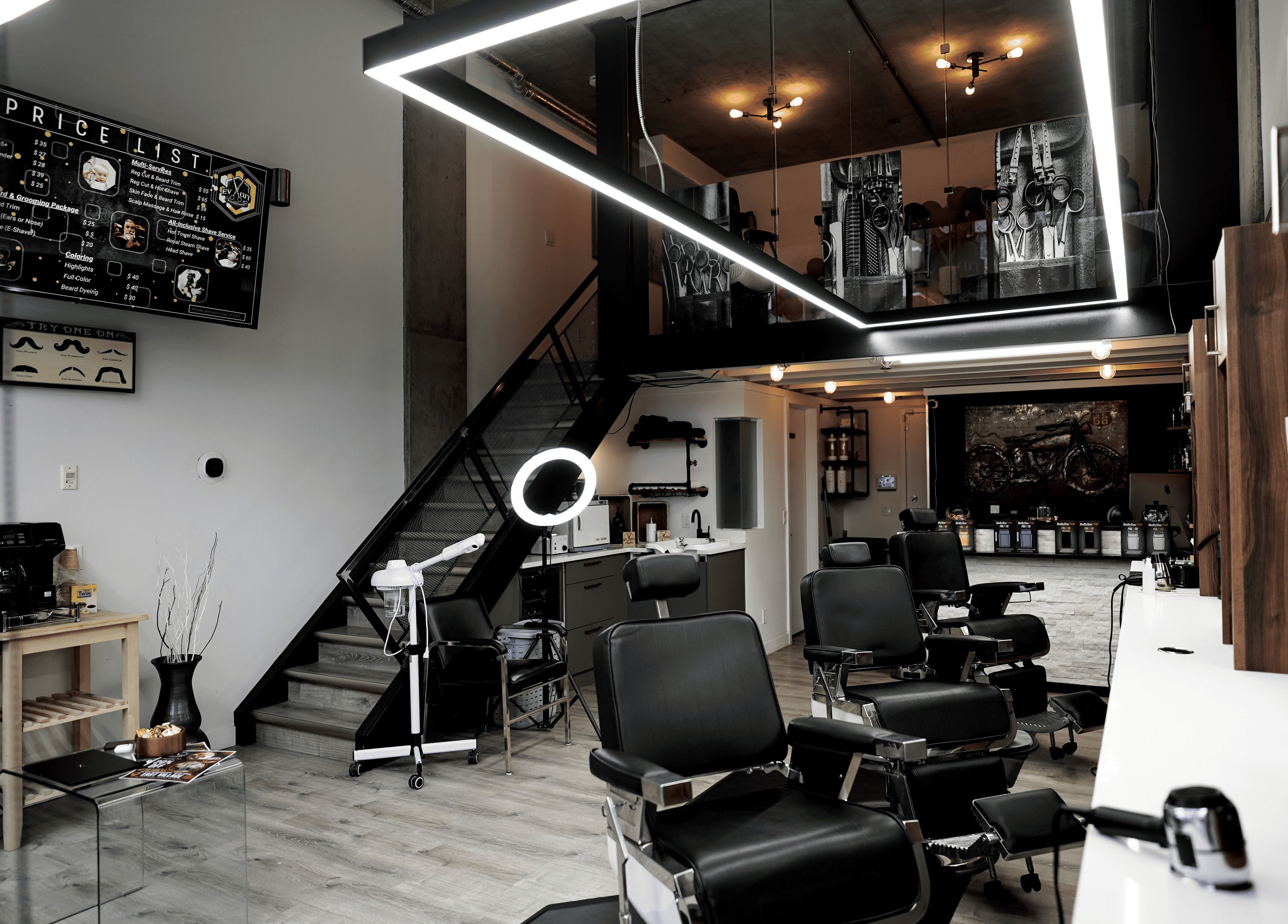 Stylish interior of Ev Cut Barbershop, Calgary, Alberta, CA with sleek black chairs and modern lighting.