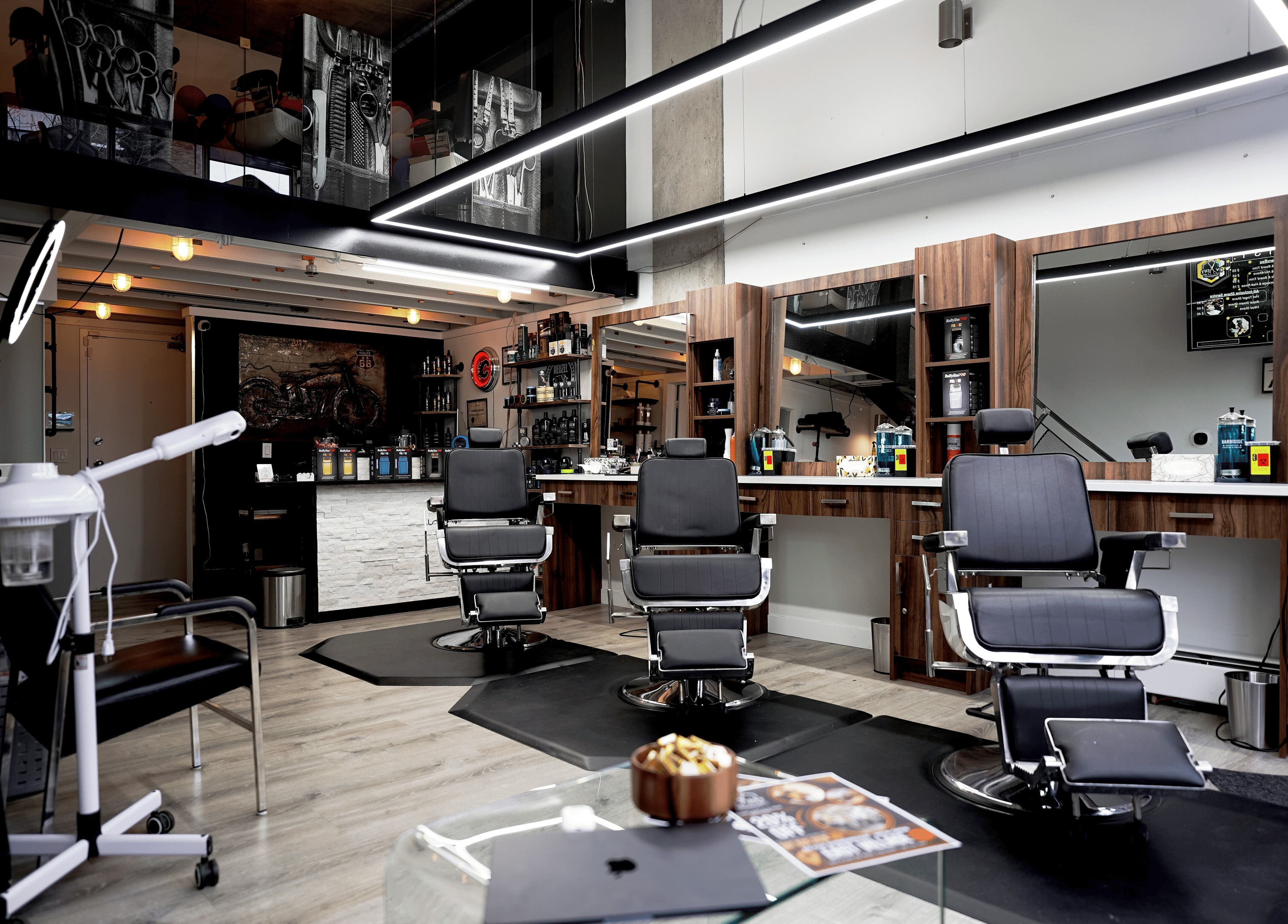 Stylish interior of Ev Cut Barbershop in Calgary, Alberta, CA showcasing barber chairs and modern decor.