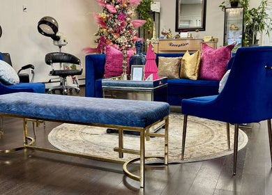 Chic lounge area at Salon Bleu by Nadine, Randolph, Massachusetts, US with plush seating and vibrant decor.