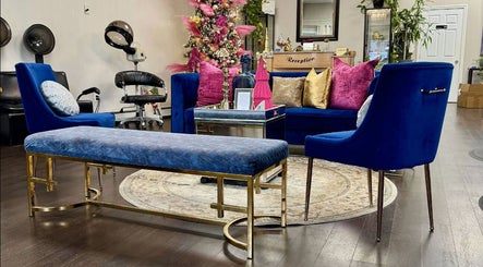 Chic lounge area at Salon Bleu by Nadine, Randolph, Massachusetts, US with plush seating and vibrant decor.