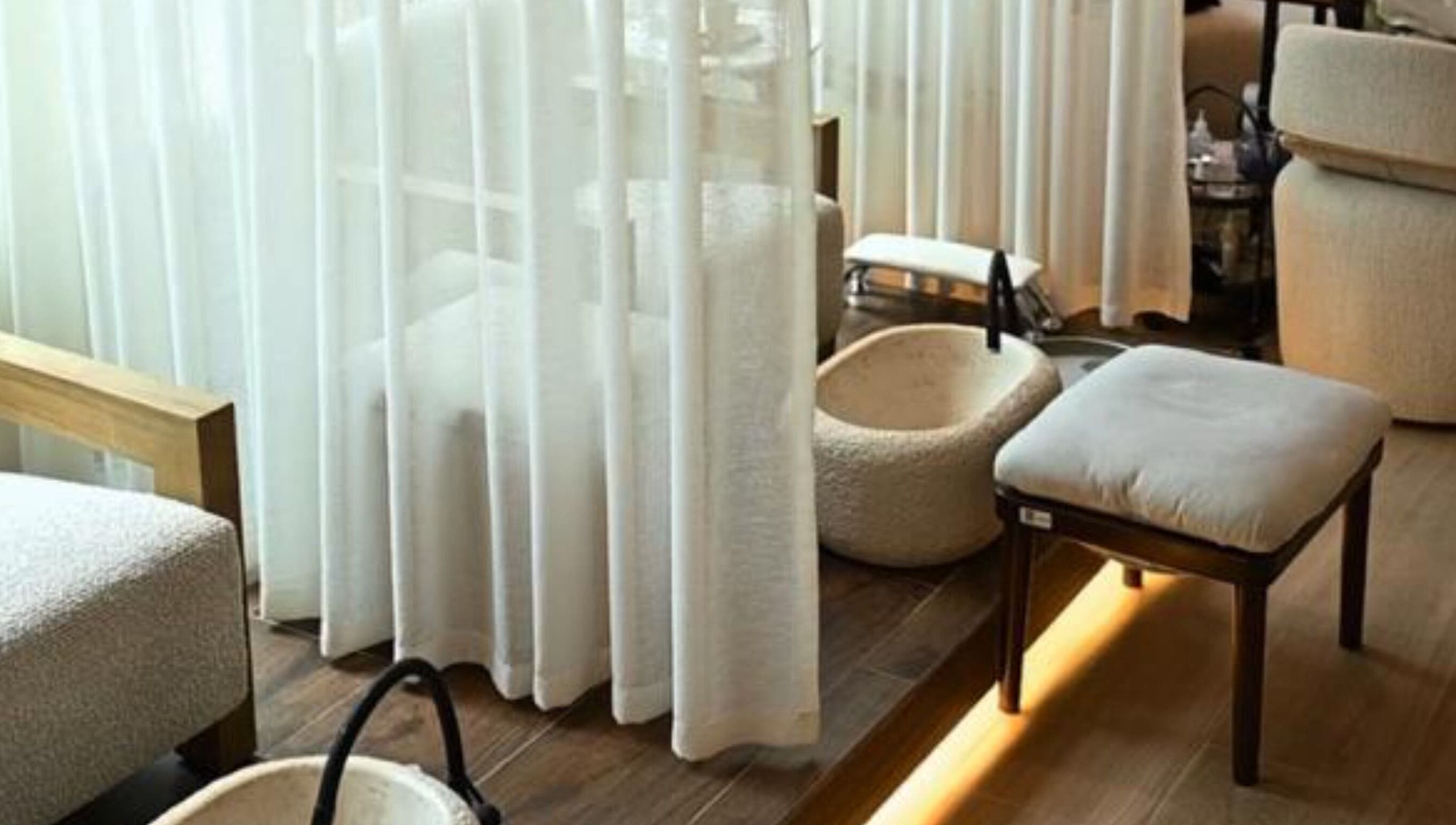 Calming pedicure area at LW Nail Bar, Riyadh. Features plush seating and basins for a relaxing experience.