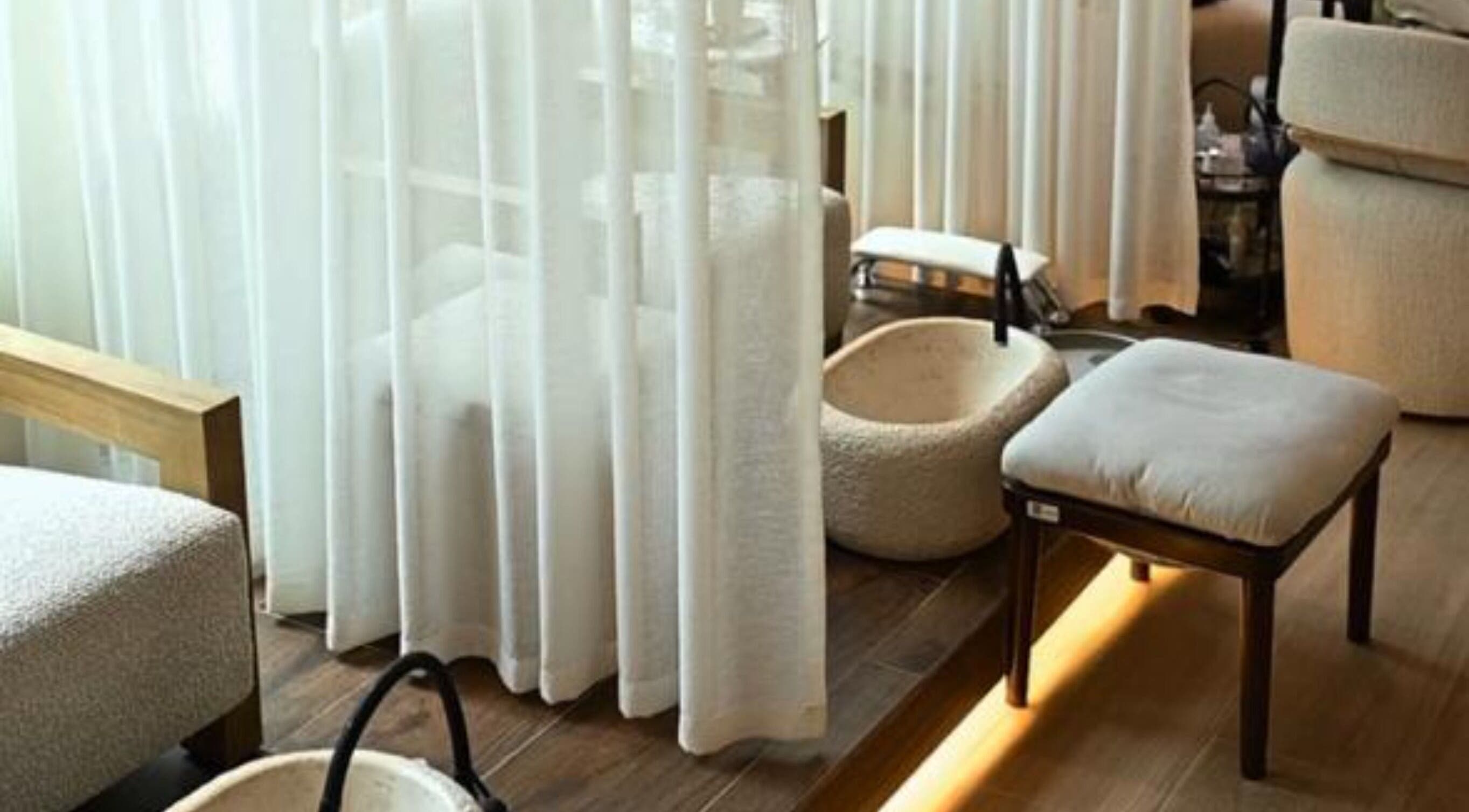 Calming pedicure area at LW Nail Bar, Riyadh. Features plush seating and basins for a relaxing experience.
