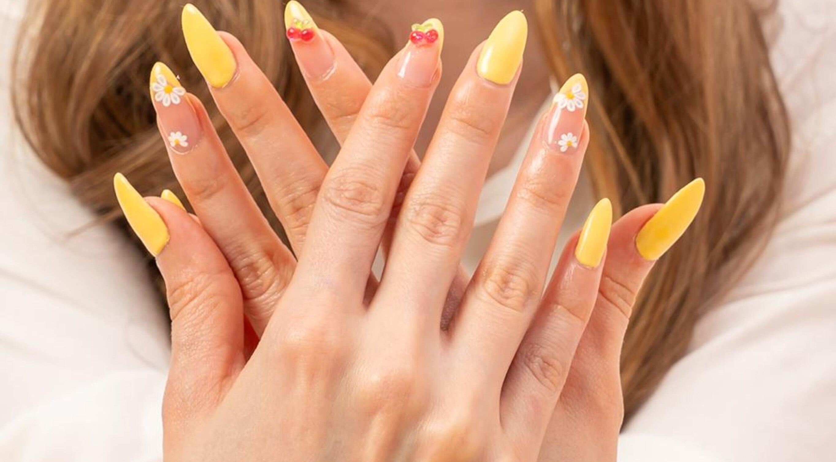 Bright yellow nail art with floral designs at LW Nail Bar, Riyadh, Riyadh Province, SA.