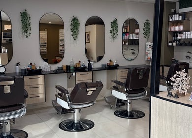 Velvet Touch Hair & Beauty in Barton features elegant styling stations with modern decor and lush greenery.