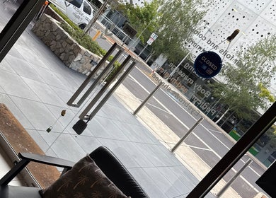 View from Velvet Touch Hair & Beauty showcasing Barton, AU's serene street and elegant glass doors.
