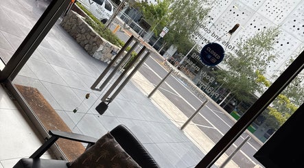 View from Velvet Touch Hair & Beauty showcasing Barton, AU's serene street and elegant glass doors.