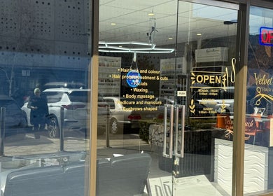 Front view of Velvet Touch Hair & Beauty in Barton, ACT, AU, showcasing its elegant glass entrance.