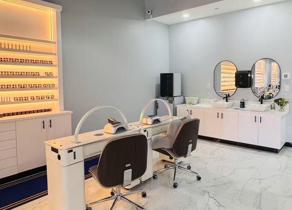 Modern nail salon setup at T & S Nails, Westfield, Indiana, US, showcasing sleek decor and manicure stations.