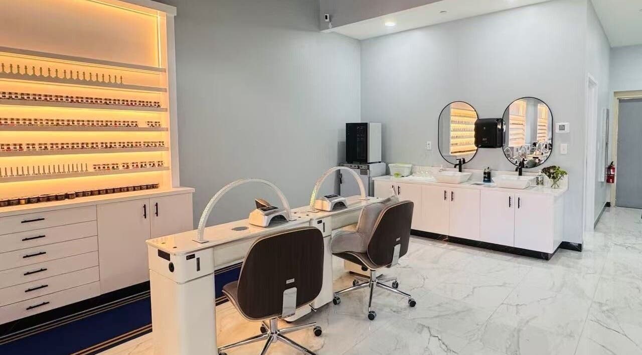 Modern nail salon setup at T & S Nails, Westfield, Indiana, US, showcasing sleek decor and manicure stations.