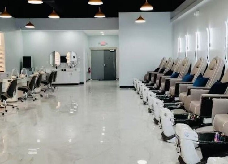 Modern interior of T & S Nails in Westfield, Indiana, featuring plush pedicure chairs and sleek manicure stations.