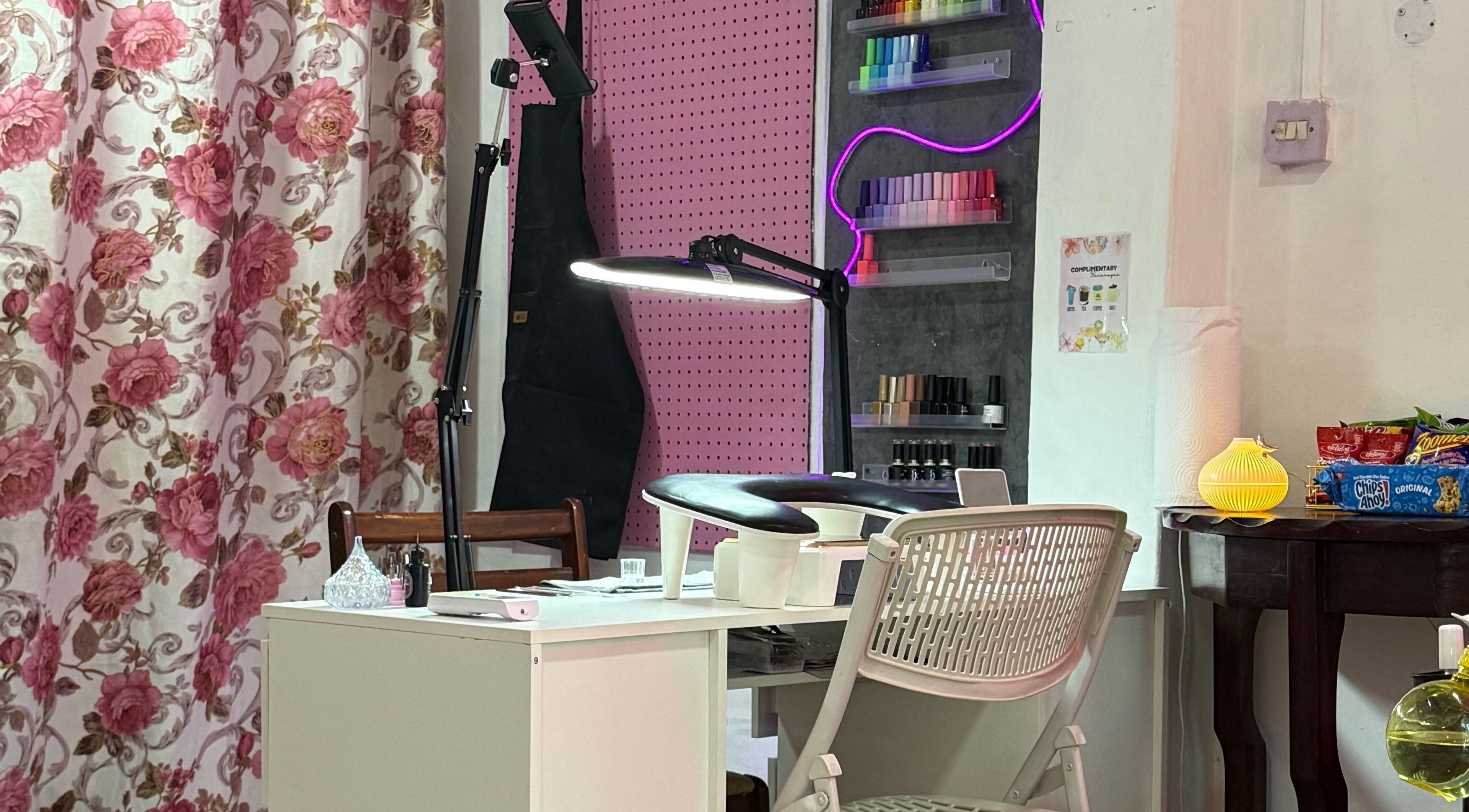 Stylish nail station at Luxe Studio, Georgetown, Demerara-Mahaica, GY, featuring vibrant decor and equipment.