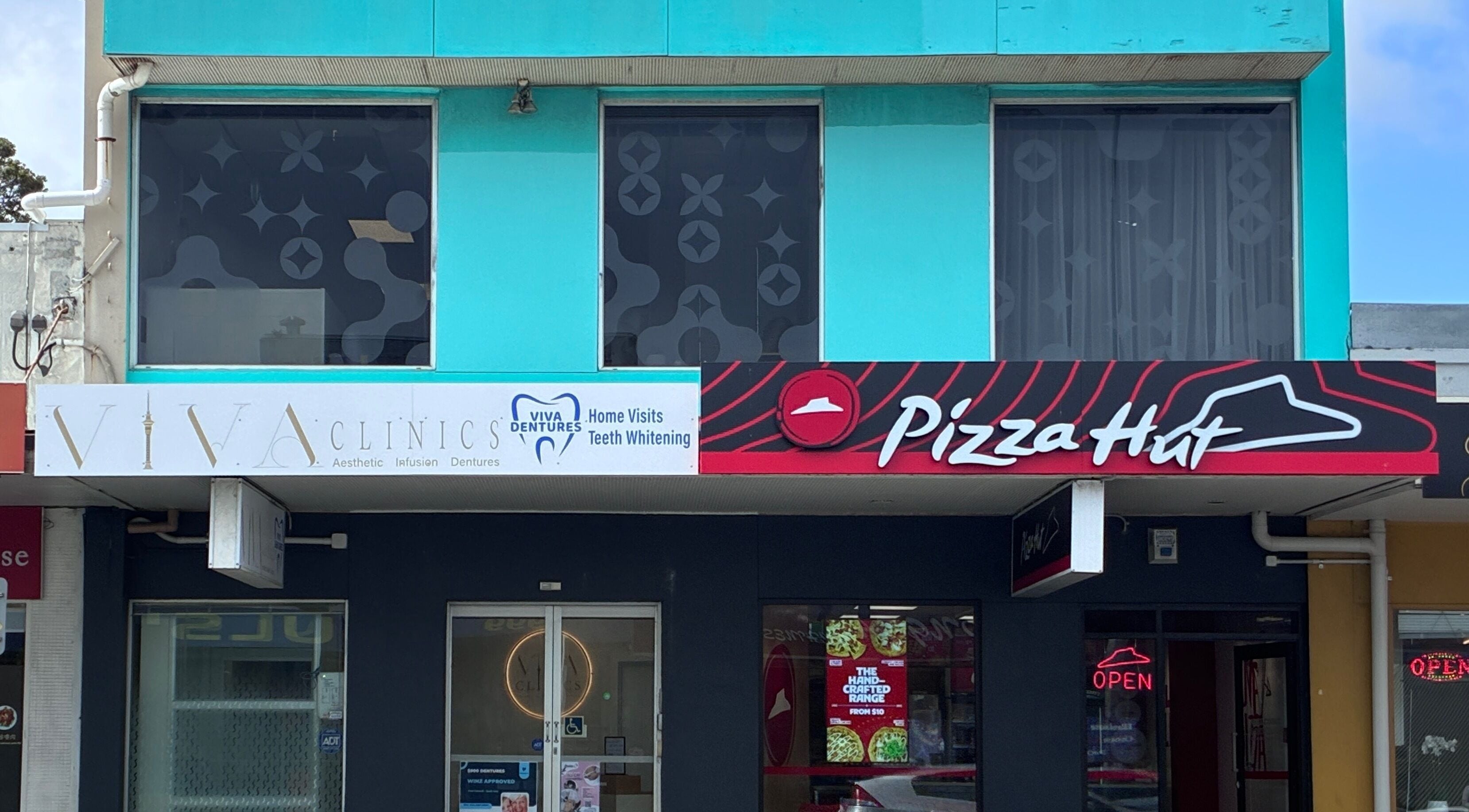 Viva Dentures storefront at Auckland, Auckland, NZ featuring modern blue facade.