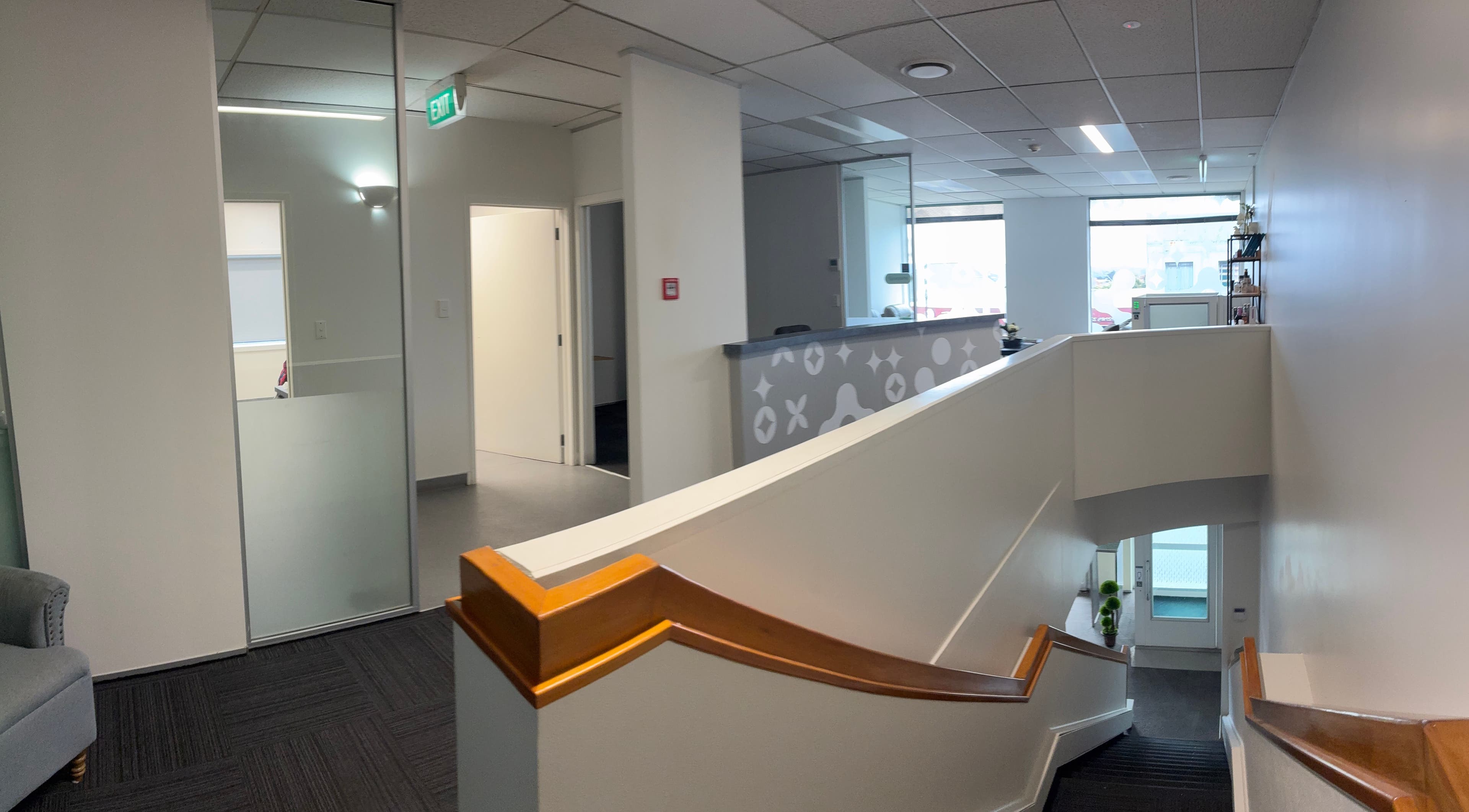Elegant interior of Viva Dentures, Auckland, Auckland, NZ showcasing a modern, welcoming stairway and reception area.