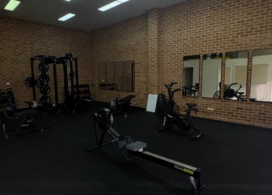 Modern gym equipment at Shift in Fairy Meadow, New South Wales, AU with brick interior and mirrors.