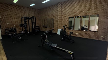 Modern gym equipment at Shift in Fairy Meadow, New South Wales, AU with brick interior and mirrors.