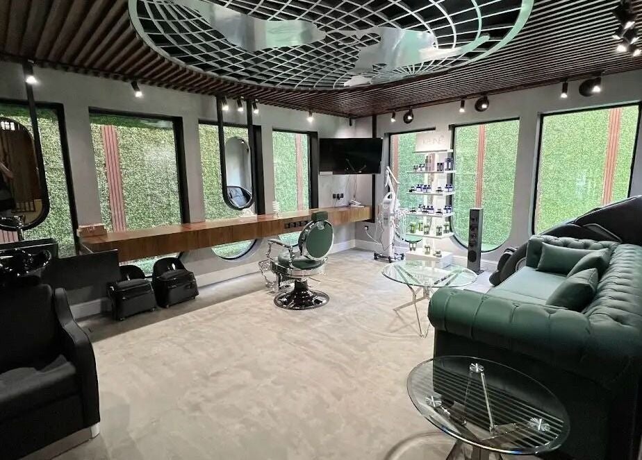 Interior of Scissor's Experts Salon, Riyadh, showcasing stylish green decor and modern furniture.