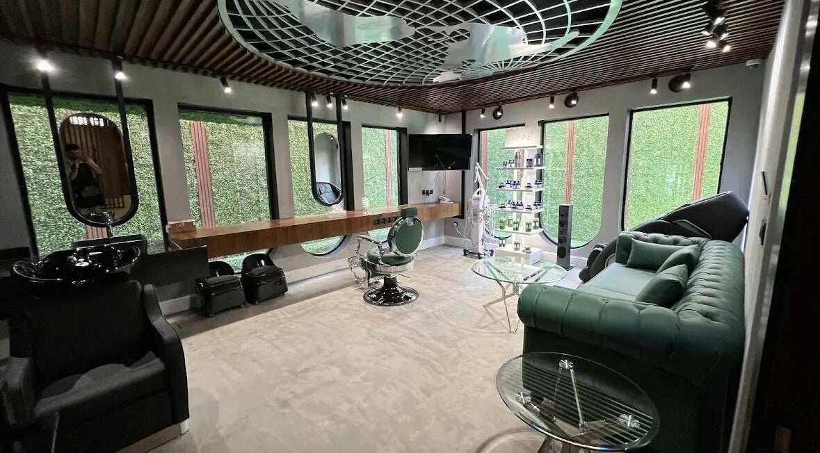 Interior of Scissor's Experts Salon, Riyadh, showcasing stylish green decor and modern furniture.