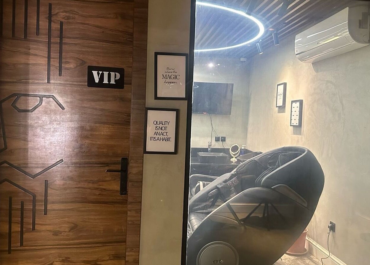 VIP room at Scissor's Experts Salon, Riyadh, featuring a luxury massage chair and stylish decor.