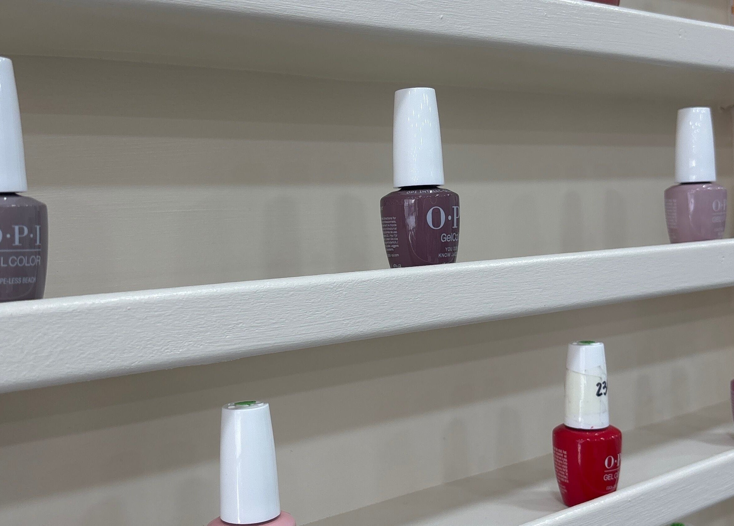 Nail polishes neatly arranged on shelves at Go Glam, London, England, GB. Elegant and vibrant hues on display.