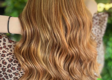 Glowing golden hair waves styled at Hair by Hannah, Blackpool, England, GB, showcasing rich color and texture.